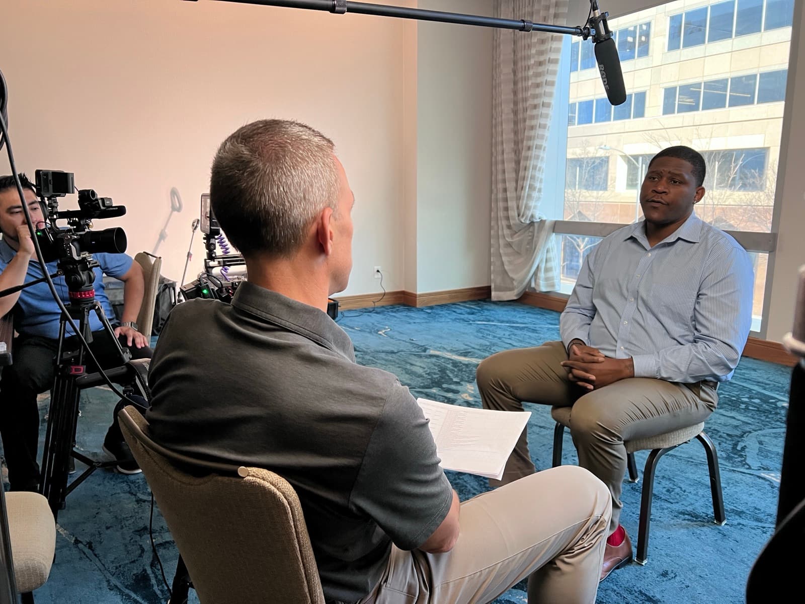An interview subject seated across from the interviewer during a recent 1708 Media production shoot.